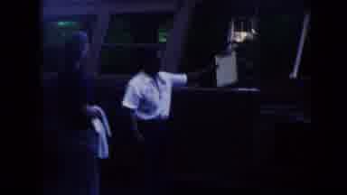 Hawaii (1961): Man With Clipboard Points To The Bus As He Speaks To The Camera As