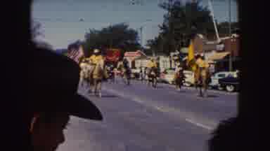 South Dakota (1954): People Riding Horses And Carrying Yellow Flags In Parade On A