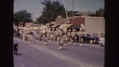 South Dakota (1954): People Dressed In Khaki Clothing Marching Down A Tree With