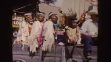 South Dakota (1954): Parade Floats Drive Down City Streets While A Crowd Watches