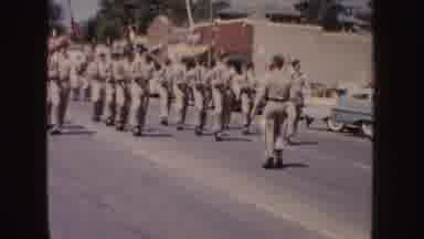 South Dakota (1954): Men Wearing Tan Uniforms March Down Street Carrying Bayonets