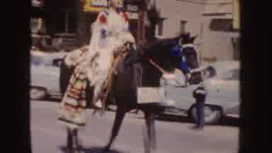 South Dakota (1954): Woman Wearing White Native American Costume Rides Brown Horse