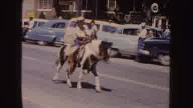 South Dakota (1954): A Boy Riding A Pony On The Street Among The People Watching
