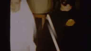 South Dakota (1954): Woman Wearing Red Dress And Masks Looks Behind Her While