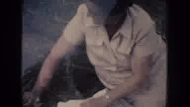 South Dakota (1954): Woman Wearing White Dress And Glasses Picks Up Checkered