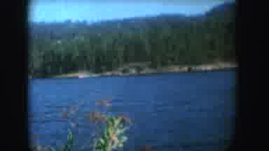 South Dakota (1954): Motor Boat On Blue Lake Pulling A Water skier Mountains And