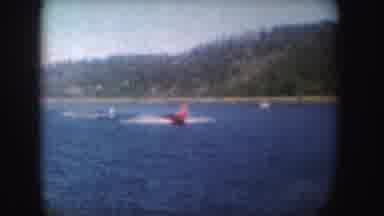 South Dakota (1954): A Red Speed Boat Moving Fast Through The Water Pulling Two