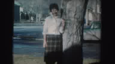 South Dakota (1954): Woman Wearing White Shirt With Brown Skirt Stands Next To