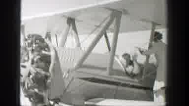 Wyoming (1939): Man Wearing White Shirt Turns Propeller Of Airplane On A Sunny Day
