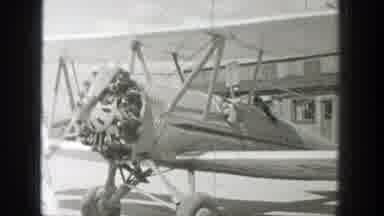 Wyoming (1939): Guy Starts The Engine Of Vintage Airplane Pilot Waves Scenery Is