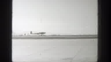 Wyoming (1939): An Antique Airplane Landing On An Airport And A Landscape Of