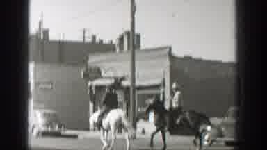 Wyoming (1939): Two Cowboy Style Man Riding Horses On The Street