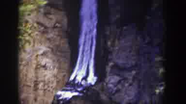 Wyoming (1939): Water Flowing Between Two Hills With Scattered Bushes In The