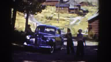 Wyoming (1939): People Near A Field Walking Away From A Parked Car And Talking