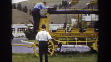 Wyoming (1939): Man Wearing Blue Shirt Climbs Down From Yellow Stagecoach On A