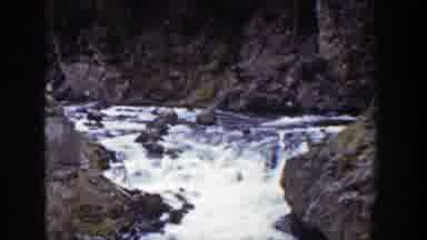 Wyoming (1939): View Of Water Flowing Over Brown Rocks On A Bright Sunny Day