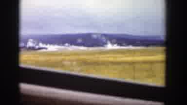 Wyoming (1939): A Mountain In The Distance Of A Large Plain And The Sign For The