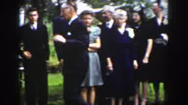 Wyoming (1939): Group Of People Standing Near A White House On A Clear Day