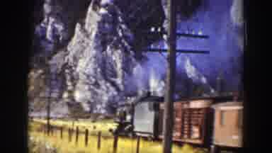 Wyoming (1939): A Train Running Near A Overhead Line And Some Mountains At The