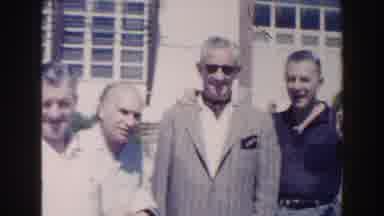 Miami Florida (1960): Man Wearing Gray Jacket And Sunglasses Waves At Camera On A
