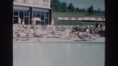 Miami Florida (1960): People Crowding At A Public Pool Sitting Beneath Umbrellas