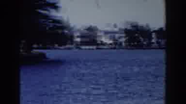 Miami Florida (1960): View Of Tan Building Blue Water And Palm Trees On A Clear
