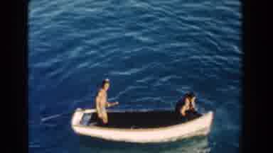 Miami Florida (1960): Two People In Small White Wooden Boat On A Clear Sunny Day