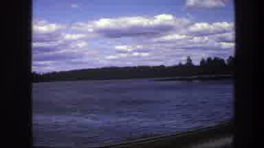 Sweden (1975): Passing View Of Lake And Green Trees On A Cloudy Day