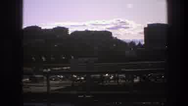 Sweden (1975): View Of Light City Traffic And Tan Buildings On A Sunny Day