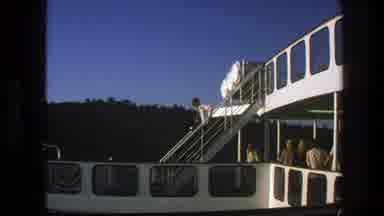 Sweden (1975): Man Wearing White Jacket Walks Down Set Of White Stairs On A Sunny