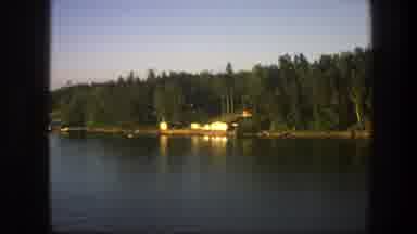 Sweden (1975): Riverbank Is Seen With Boat Trees House River Water Outside