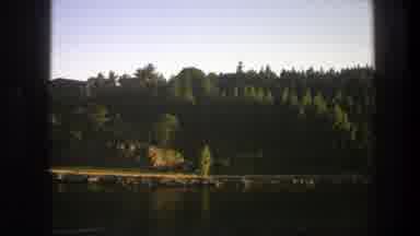 Sweden (1975): A Clip Showing A Still Water Body And Its Surrounding Bushy Areas