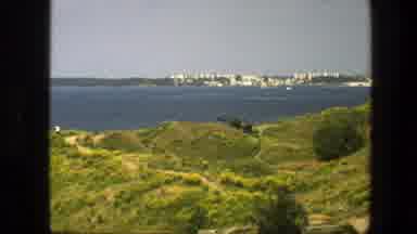 Sweden (1975): Rolling Green Hills With Calm Blue Water On A Sunny Day