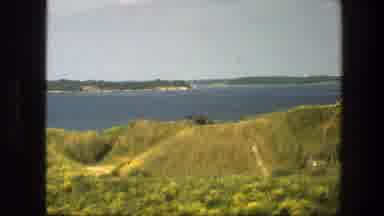 Sweden (1975): View Of Brown Building And Green Grass On A Clear Sunny Day