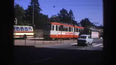 Sweden (1975): View Of Parked Orange And White Electric Trolley Train On A Sunny