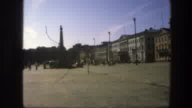 Sweden (1975): Zooming In On A Street Sign In The Public Square Near A Statue