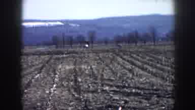Nebraska-1958: Two Cars Drive Down A Country Road And Two Men Take A Break On A