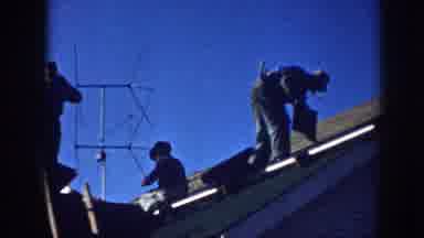 Nebraska (1958): Men Repairing Roof Of A White House On A Clear Day