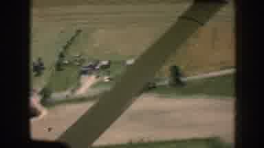 Nebraska (1958): Aerial View Of Gray Buildings And Green Trees On A Sunny Day