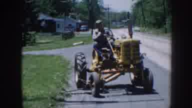 Nebraska (1958): Man Driving A Yellow Tractor