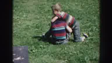 Nebraska (1958): Three Kids Playing Fights At The Grass Of A Backyard With S