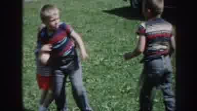 Nebraska (1958): Three Kids Playing On Green Grass On A Bright Sunny Day