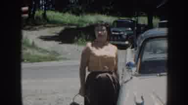 Nebraska (1958): A Woman Stands Besides A Car And Walks Back To Her Own After A