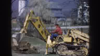 Nebraska (1958): A Guy Driving A Backhoe At A Farm And Then A Little Boy Running