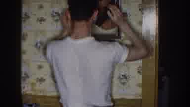 Nebraska (1958): A Young Man Standing In The Mirror Grooming His Hair