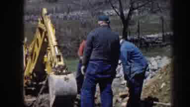 Nebraska (1958): A Group Of Men Using Machinery To Hoist A Large Object Out From