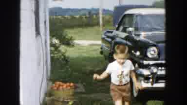 Michigan (1958): A Little Boy Running By A Black Car At The Backyard Of A House