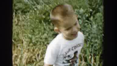 Michigan (1958): A Boy Plays Outside A Largely Decorated Brown Painted Building
