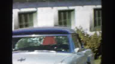 Michigan (1958): Two Young Boys In Red Coats Run Around A House While Another Boy