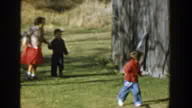 Michigan (1958): Girl Wearing Red Dress Runs After Small Boy Wearing Red Sweater